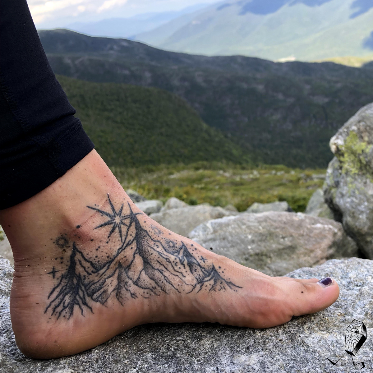 Mountain tattoo on the right foot