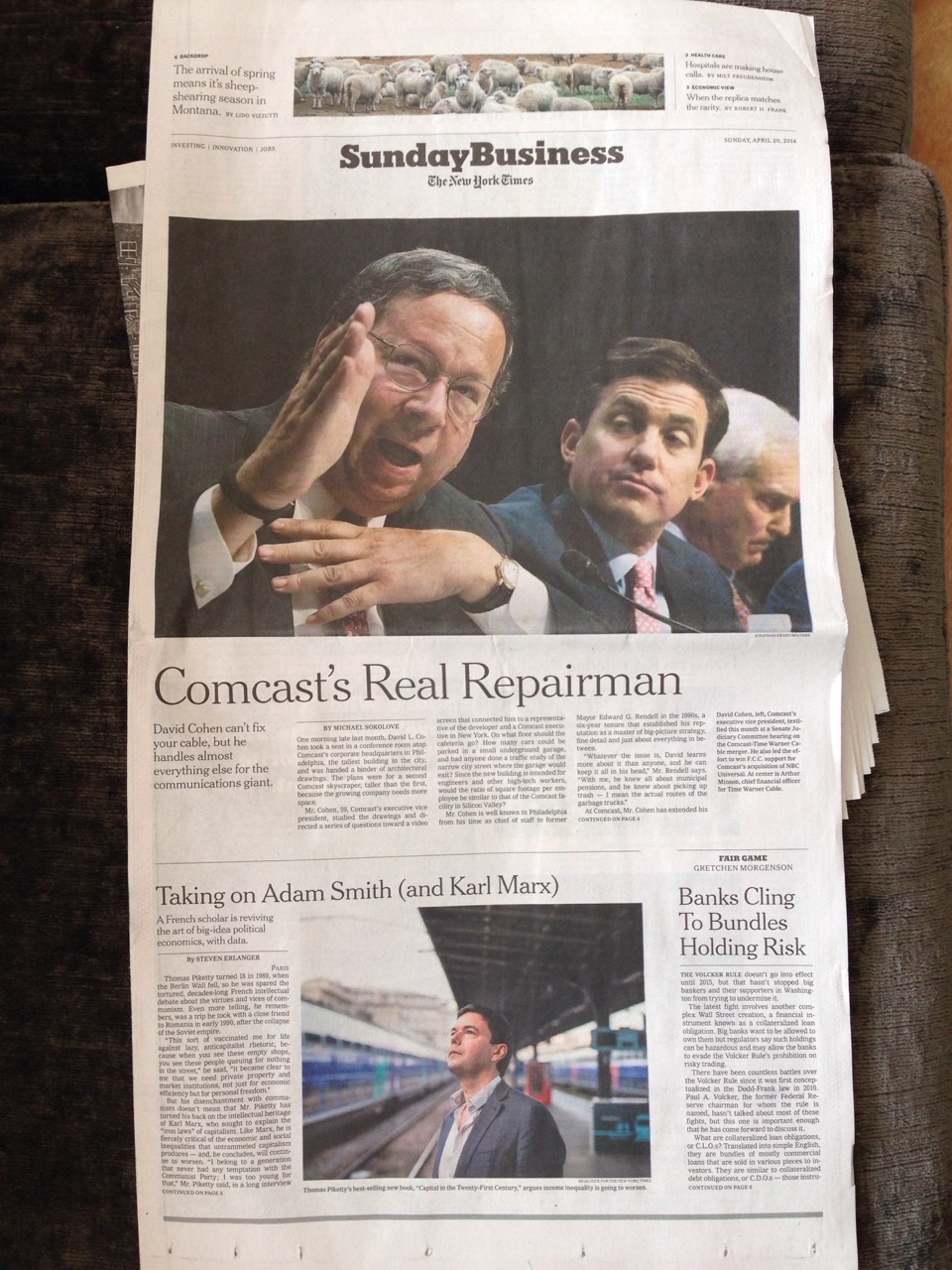 Four white men and a flock of sheep are featured on the front of the Sunday Business section of The New York Times on April 20, 2014.