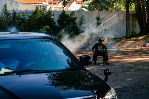 A man sits on guard of a parking lot.