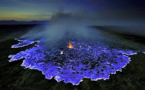end0skeletal:  The blue flames of Indonesia’s Ijen volcano are caused by super-heated sulfuric gases forcing their way to the surface. Upon hitting open air, the gases ignite, sometimes shooting flames as high as 16 feet.   Some of the gases condense