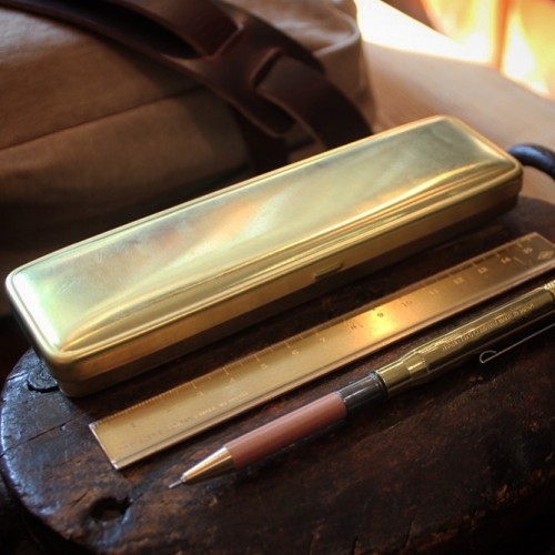 This solid brass pen case by Traveler&rsquo;s Company is a sturdy place to hold your writing tools. 