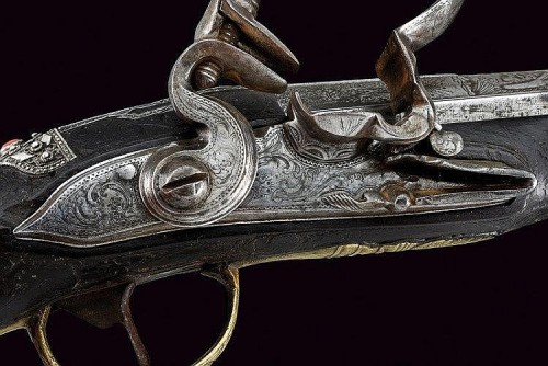 An engraved, silver and red coral decorated flintlock pistol marked “Cominazo Lazaro”, I