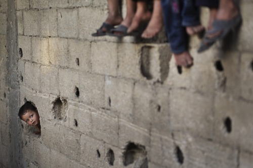 Palestinian refugee children play in a poverty-stricken area of Beit Lahia, Gaza Strip on April 28, 