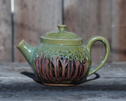 ringmastergoldie:  I’ve been working on trying my hand at double walled functional object recently. This teapot was thrown to two walls and closed at the top to make a ledge for the lid. Then, I cut into the top layer of clay to create the illusion