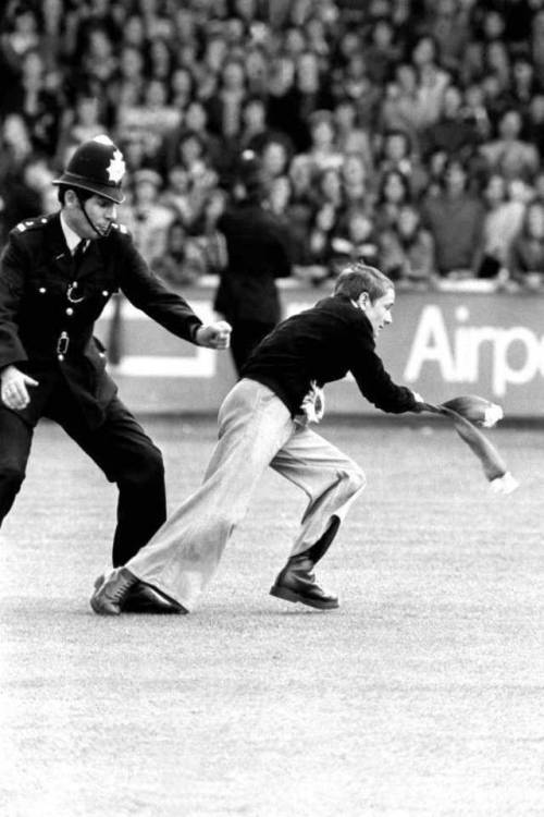 A Manchester United fan is chased by a policeman   1974