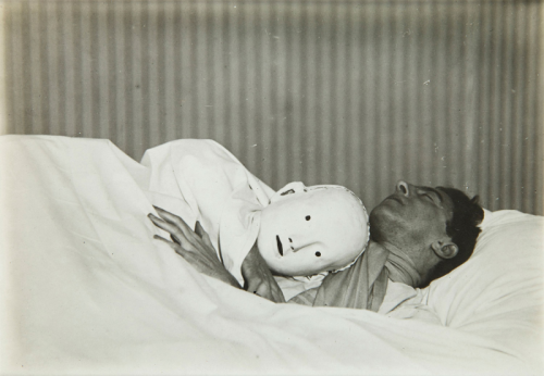 grilledcheese666:  Jean Cocteau in Bed with Mask, 1927 – Berenice Abbott  the mask is me 