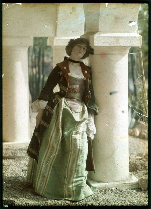 Photograph of a woman in historical costume, looks like an early-mid 18th century riding coat and dr