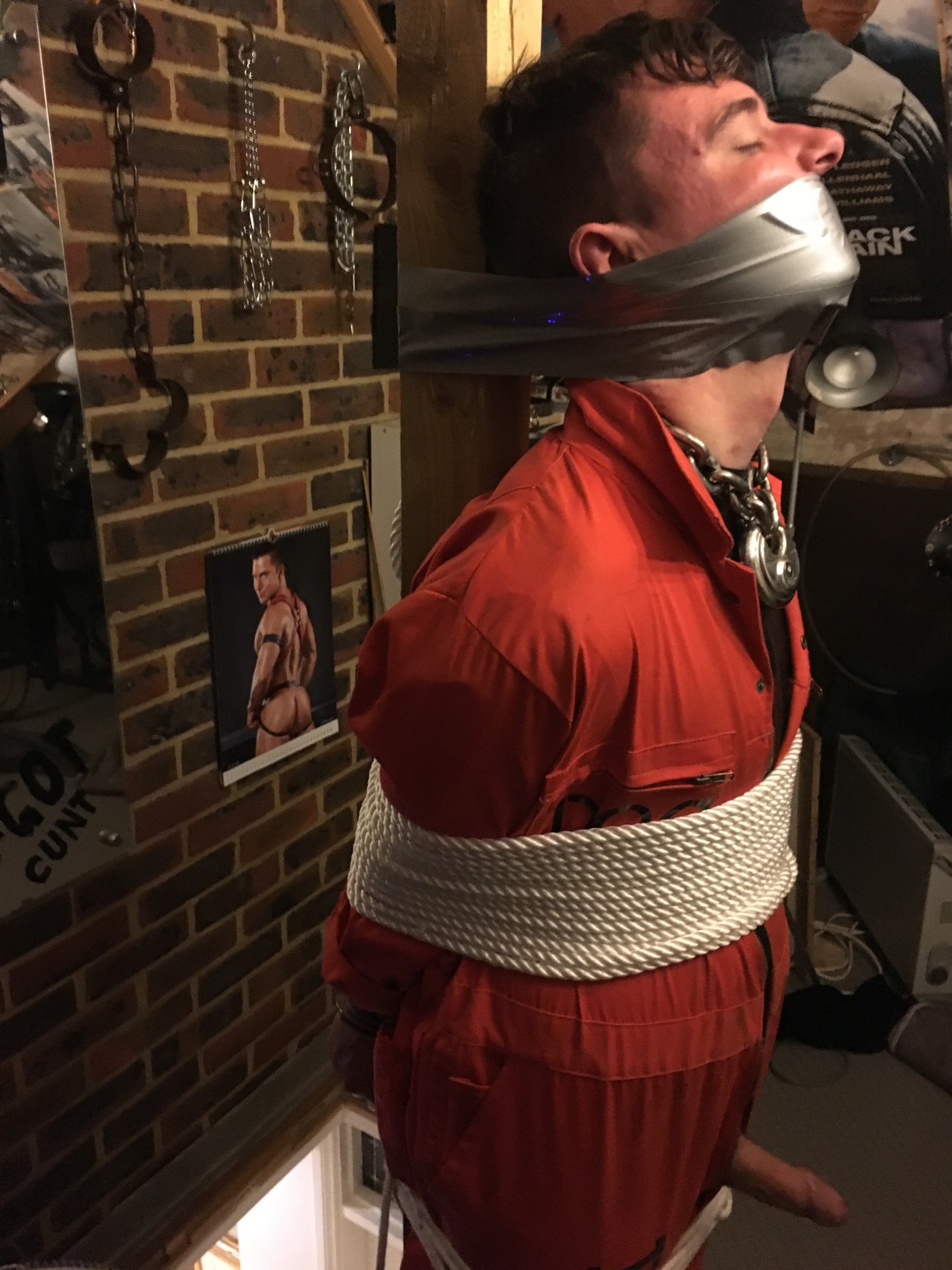 jamesbondagesx: Intruder in uniform and secured in sleep sack, tied to post and milked