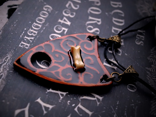 forgetallyouarein80s:  New ouija inspired pendants will be on sale very soon! I need your opinion: does it make sense to make more such planchette pendants with crystals, bones etc ?
