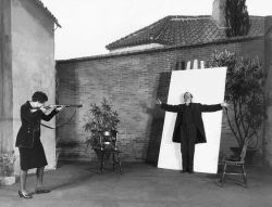 hauntedbystorytelling:  Alexander [Sasha] Stewart :: A Shot at Art. A woman takes aim with a gun, and prepares to shoot a man standing in front of a canvas, in a scene from the play `Fortunato’, 1928. | src Getty Images more [+] by this photographer