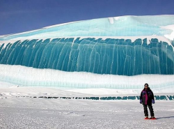 sixpenceee:While they look like frozen waves, they are not. These formations are created in Antarctica over time. Most of these images result from melting, not from freezing. Melting has produced the downward pointing spikes that look like a breaking wave