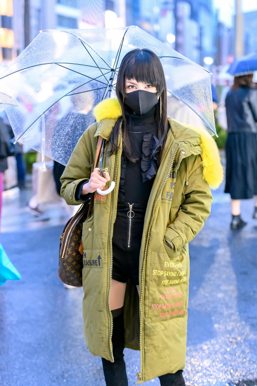 18-year-old Japanese student Mikael on the street in Harajuku in the rain with a black face mask, lo