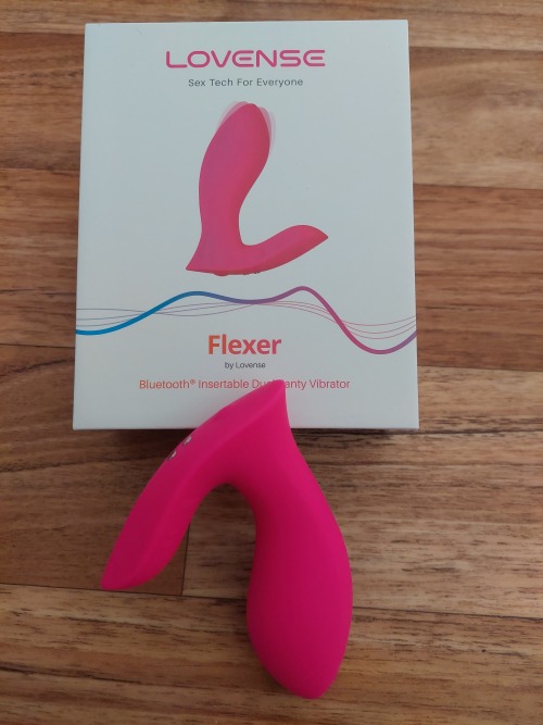 A picture of the Lovense Flexer in front of the packaging.
