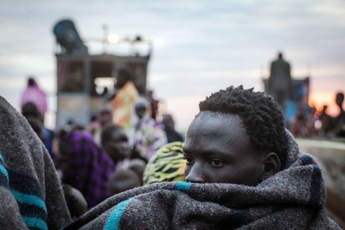untrustyou:  IN THOUGHT: A man waited as other people fleeing violence in the Bor region unloaded belongings in Minkammen, South Sudan, Thursday. Jan. 9, 2014. Nichole Sobecki/AFP/Getty Images