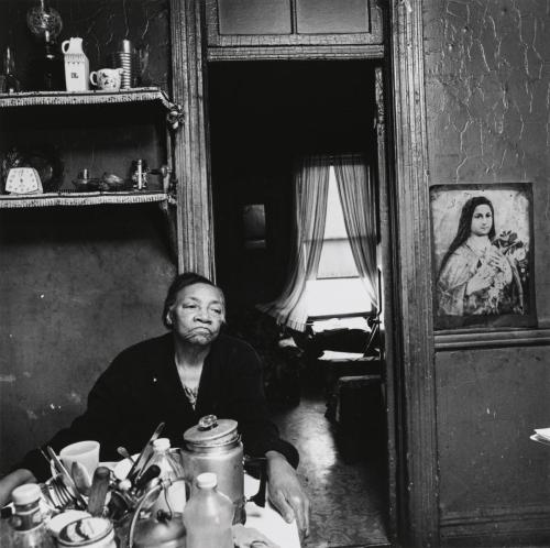  Bruce Davidson.  Woman in Kitchen with Madonna (East 100th Street Series), between 1966 and 1968.  