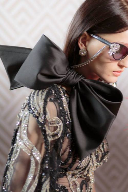 Couture eyewear gets its own embellishments with strings of gold and pearl chains dropping down to t