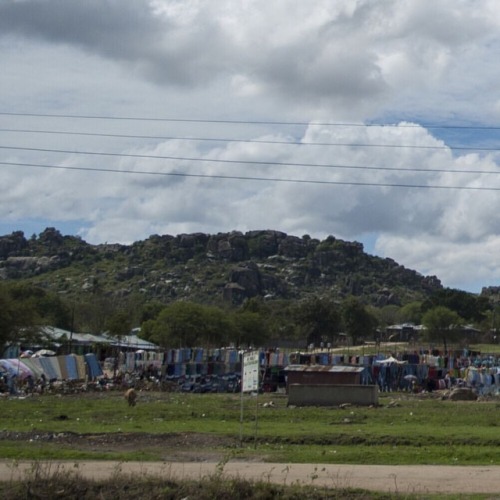 A Cyclist Rolls Past A Market In Mwanza, Tanzania. #mwanza #tanzania #africa #bicycle #cyclist #market