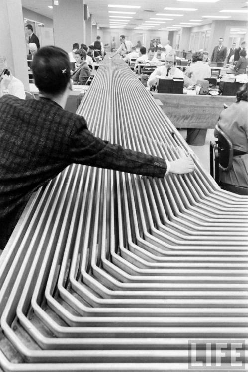 Conveyor belt in the order room of Hayden, Stone & Co.(Eliot Elisofon. 1962)