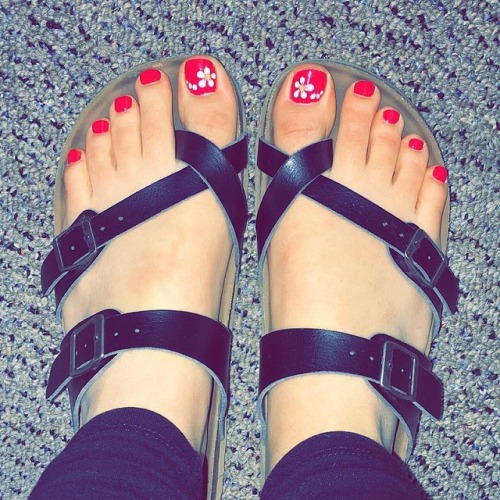 Pretty feet in Birkenstock toe cross sandals.