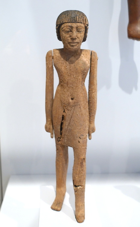 Ancient Egyptian wooden statuette of a man striding forward.  Artist unknown; 6th Dynasty (ca. 