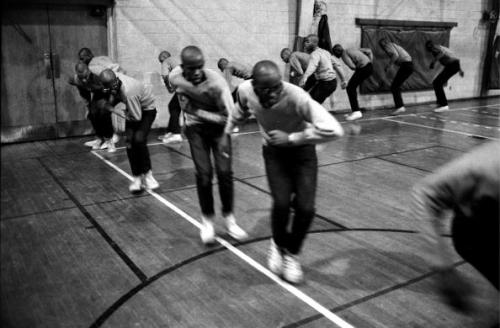 Fraternity pledges for Omega Psi Phi practice their stepping routine in the Fisk University gymnasiu