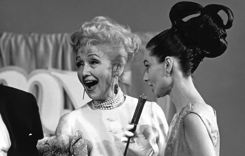 Audrey Hepburn with Hedda Hopper photographed by Chester Maydole at the My Fair Lady premiere, 1964&