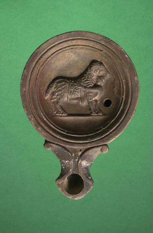 ancientgoatart: Campanian lamp with Odysseus clinging to the belly of the Cyclops’ ram said to be fr