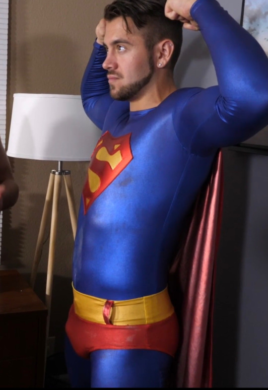 hotudla:“Whenever you hear the word ‘SuperCockSucker’ all your powers will fade away”. 🍆💪🏻💥Evil Michael Delray is in his office plotting evil stuff. He has a huge rock hard boner, bulging through his red spandex pants. Superman (Dante