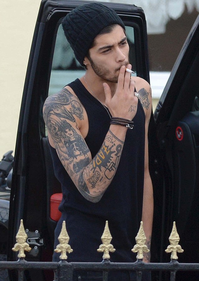 direct-news:  Zayn Malik puffs on a cigarette outside his £24-a-night hotel as he