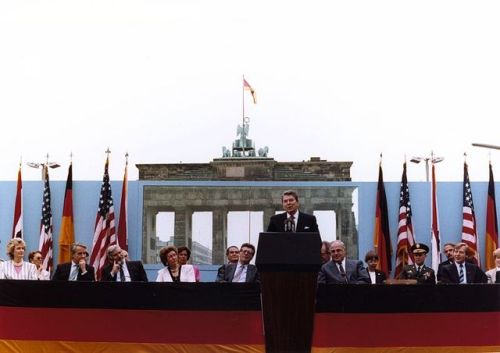 Ronald Reagan speaking at the Brandenburg Gate, challenging MikhailGorbachev to “tear down this wall