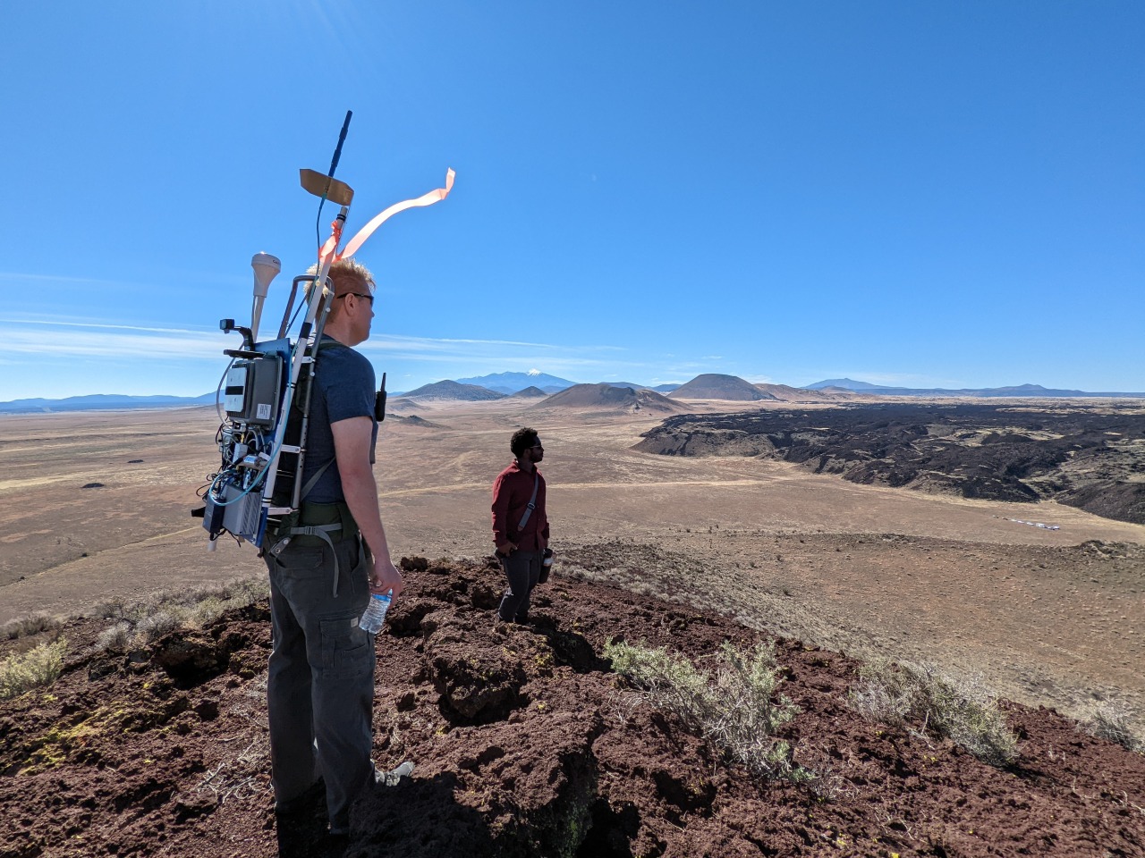 Two engineers look across the vast Arizona desert as they test new 4G and 5G communications technologies. Credit: NASA/Glenn Research Center