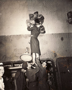 sharontates: Marlene Dietrich welcomes a soldier returning from World War II with a passionate kiss through a porthole, 1945. Photo by Irving Haberman.