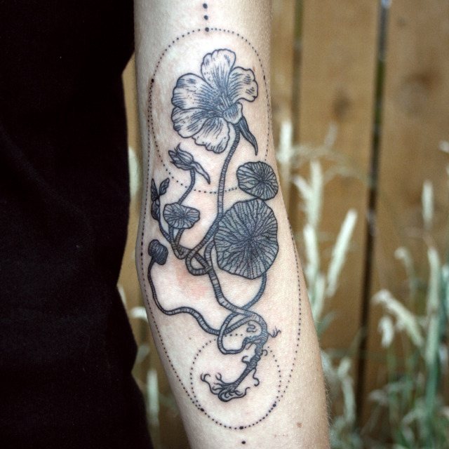 Nasturtium and pansies tattooed on the thigh.