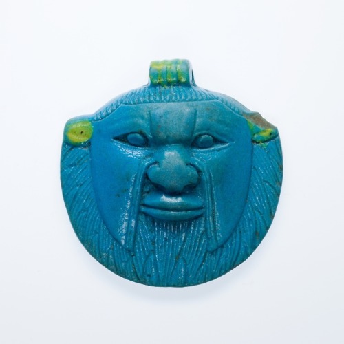 Ancient Egyptian faience amulet depicting the head of the dwarf-god Bes.  Artist unknown; ca. 664-33