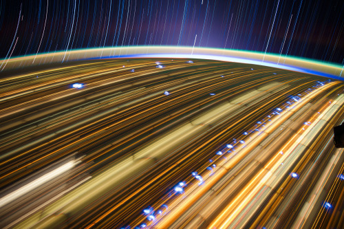 skunkbear:  These are a couple years old, but my love for them springeth anew. Long exposure photographs (by astronaut Don Pettit aboard the International Space Station) turn human lights into neon threads, stars into shining strings, and lightning storms