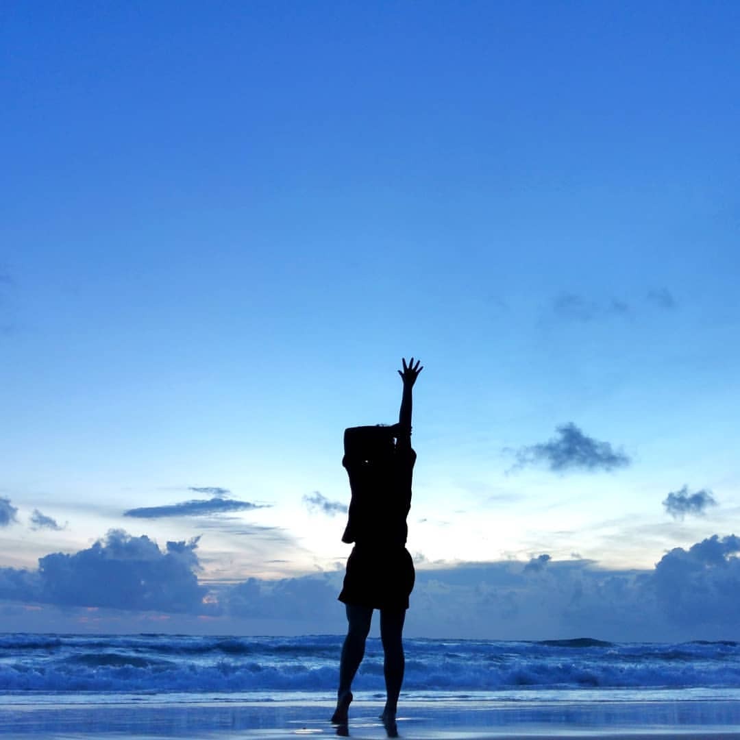 Young attractive woman practices yoga in extended side angle pose on the  beach. Stock Photo | Adobe Stock