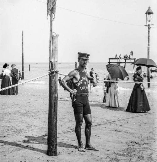 A 1906 photograph of a lifeguard on duty at Brighton Beach in New York City.