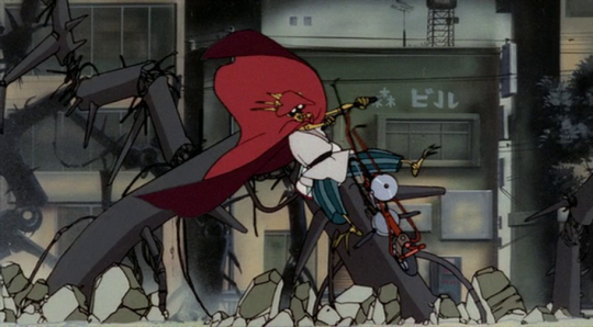 Still from 'Chicken Man and Red Neck', with a skinny robot in a red cloak on a scooter.