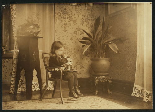 onceuponatown:New York: Little girl conversing with a Campbell Kid doll. 1912.