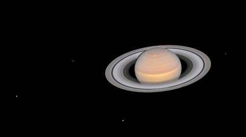 Saturn and its moons at opposition (The visible moons are (from left to right) Dione, Enceladus, Tet