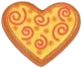 sticker of a gingerbread cookie shaped like a heart and decorated with yellow frosting and orange swirls.