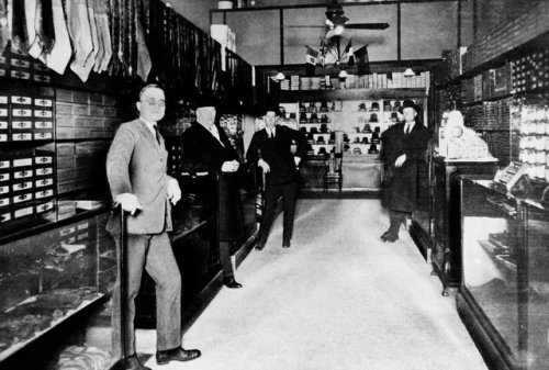 Harry S. Truman, left, in the haberdashery (men’s accessory store) he operated in Kansas City, Misso