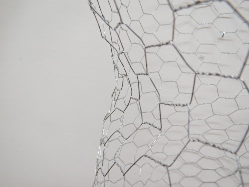 Macro images documenting the subtle curves of the body that the wire molds have captured. 