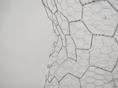 Macro images documenting the subtle curves of the body that the wire molds have captured.