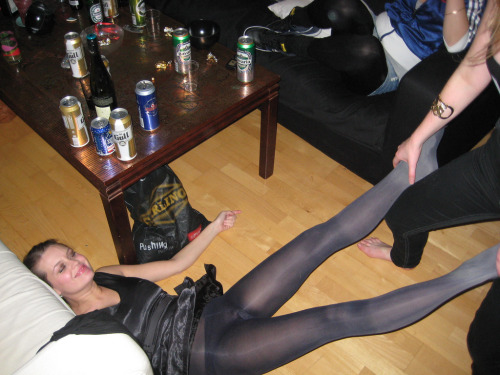 partying girl in black pantyhose and short satin dress. Woman in pantyhose