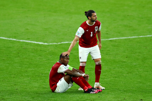 Aleksandar Dragovic consoles teammate David Alaba after the match vs. Italy