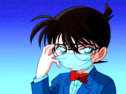 A second GIF from the "Kimi to Yakusoku Shita Yasashii Ano Basho Made" sequence. Against a purple-blue background, what looks like Conan Edogawa wearing a facemask is revealed to really be Ai Haibara as she rips off the mask, a wig, and Conan's glasses. She smiles. Then, against an orange background, Heiji wipes makeup off his face and smiles. Finally, against a blue background, Shinichi, wearing the knight outfit for his school play, removes the helmet and smiles, too.