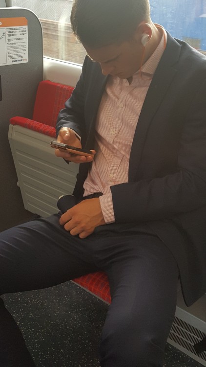 suitman89:  Manspreading on the train, showing off his suited bulge…