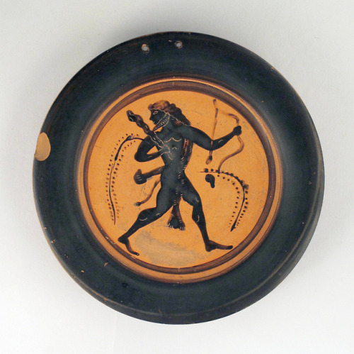 Heracles, armed with bow, club, and sword.  Attic black-figure terracotta plate, artist unknown