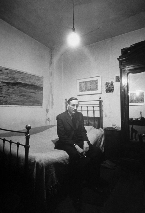 moredarkthanshark:William S. Burroughs in his room at the Beat Hotel, Paris, France, 1958 by Loomis 